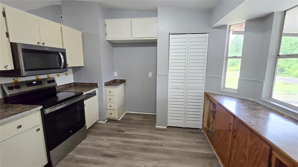 3410 15th Street Southwest Lehigh Acres, FL 33976 - Photo 9 of 31 a kitchen with a sink and steel appliances