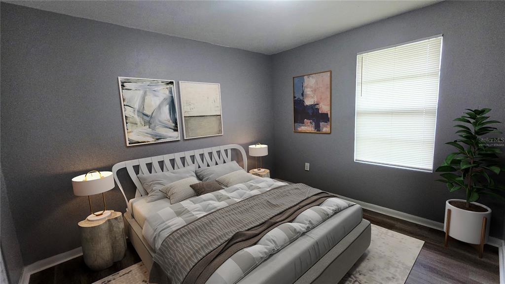 3410 15th Street Southwest Lehigh Acres, FL 33976 - Photo 10 of 31 a bedroom with a large bed and a potted plant