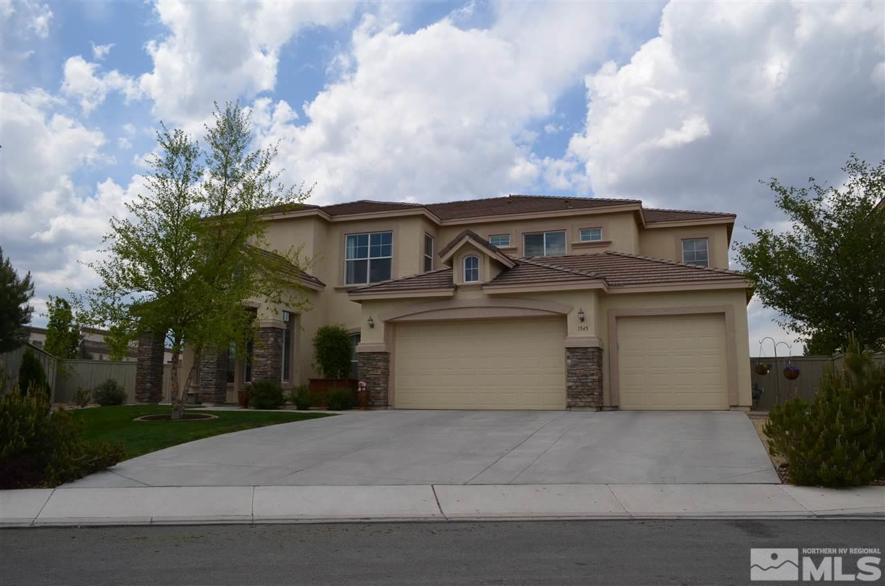1545 Bethal Court Reno, NV 89521 - Photo 1 of 1 a front view of a house with a yard and garage