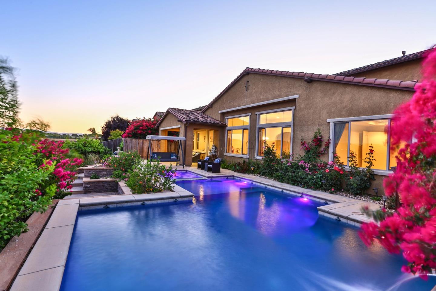 4192 Chiavari Way Manteca, CA 95337 - Photo 15 of 67 a view of a house with swimming pool and potted plants