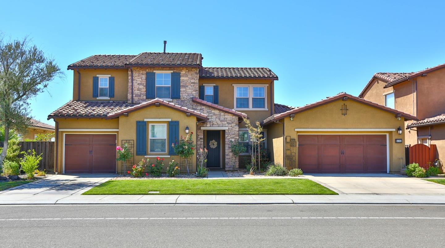 4192 Chiavari Way Manteca, CA 95337 - Photo 2 of 67 a front view of a house with a yard and garage