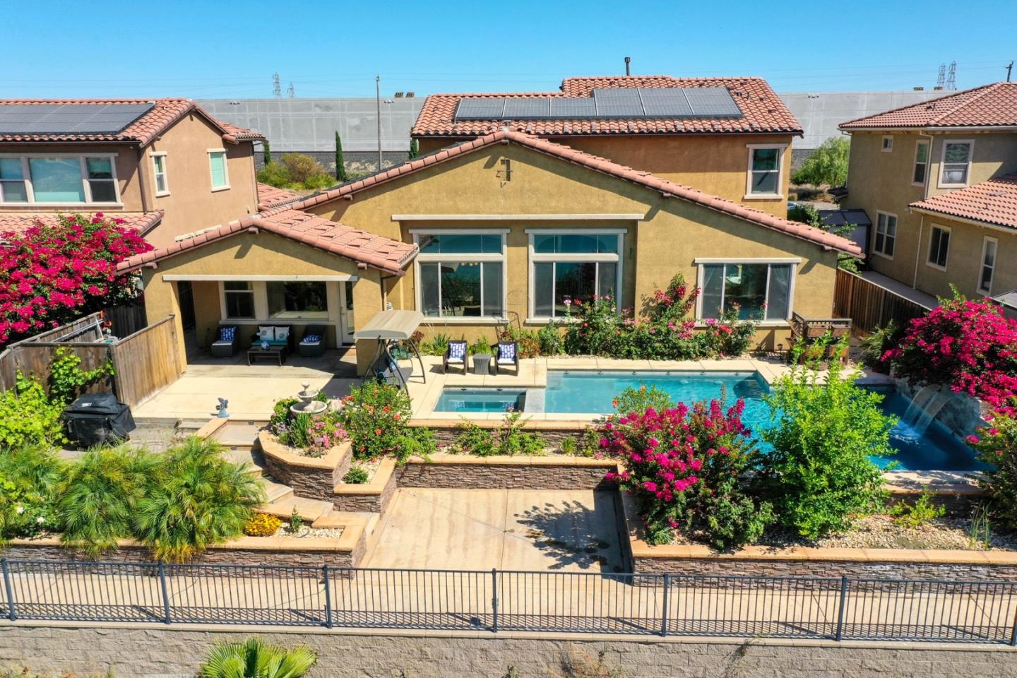 4192 Chiavari Way Manteca, CA 95337 - Photo 23 of 67 a front view of a house with lots of flowers planted