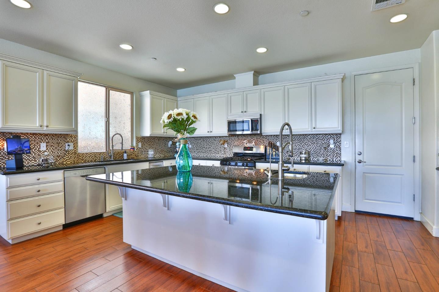 4192 Chiavari Way Manteca, CA 95337 - Photo 26 of 67 a kitchen with stainless steel appliances granite countertop wooden cabinets a granite counter tops and a hard wood floors