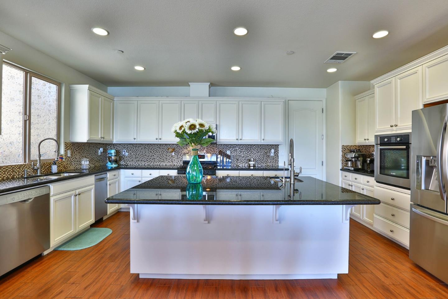 4192 Chiavari Way Manteca, CA 95337 - Photo 27 of 67 a kitchen with kitchen island granite countertop a sink a counter top space and stainless steel appliances