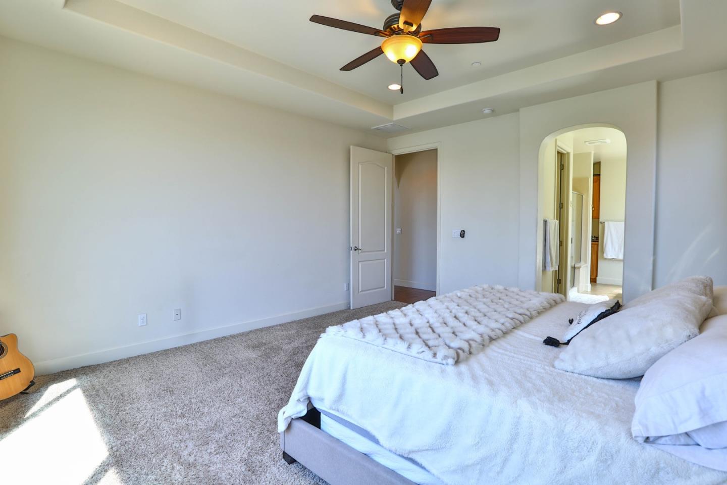 4192 Chiavari Way Manteca, CA 95337 - Photo 41 of 67 a bedroom with a bed and a chandelier