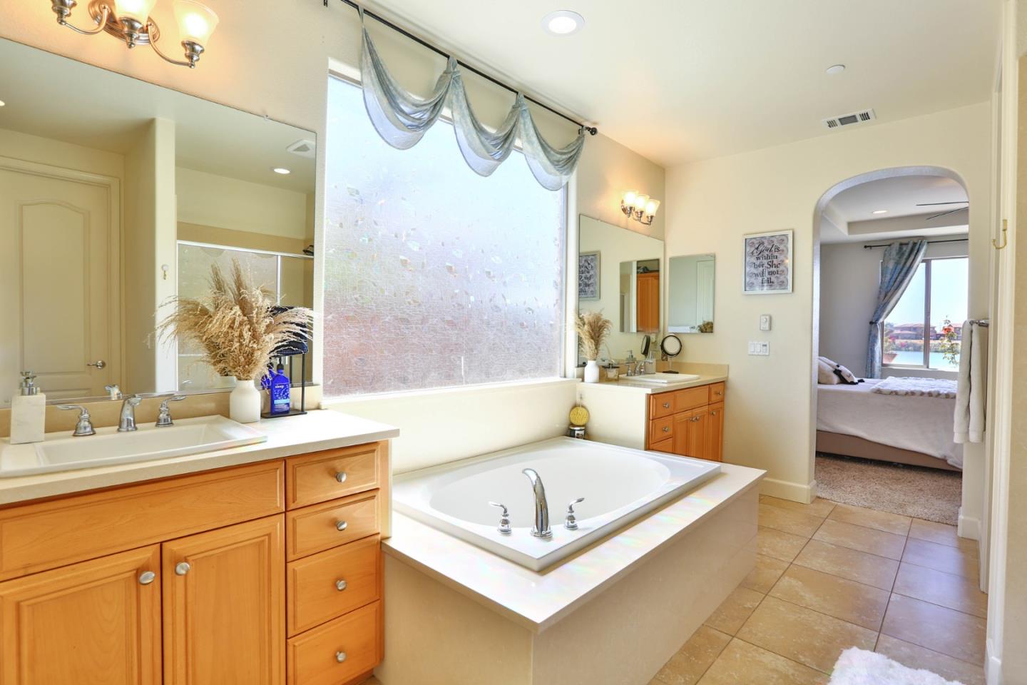 4192 Chiavari Way Manteca, CA 95337 - Photo 44 of 67 a bathroom with a sink a vanity a mirror and a shower
