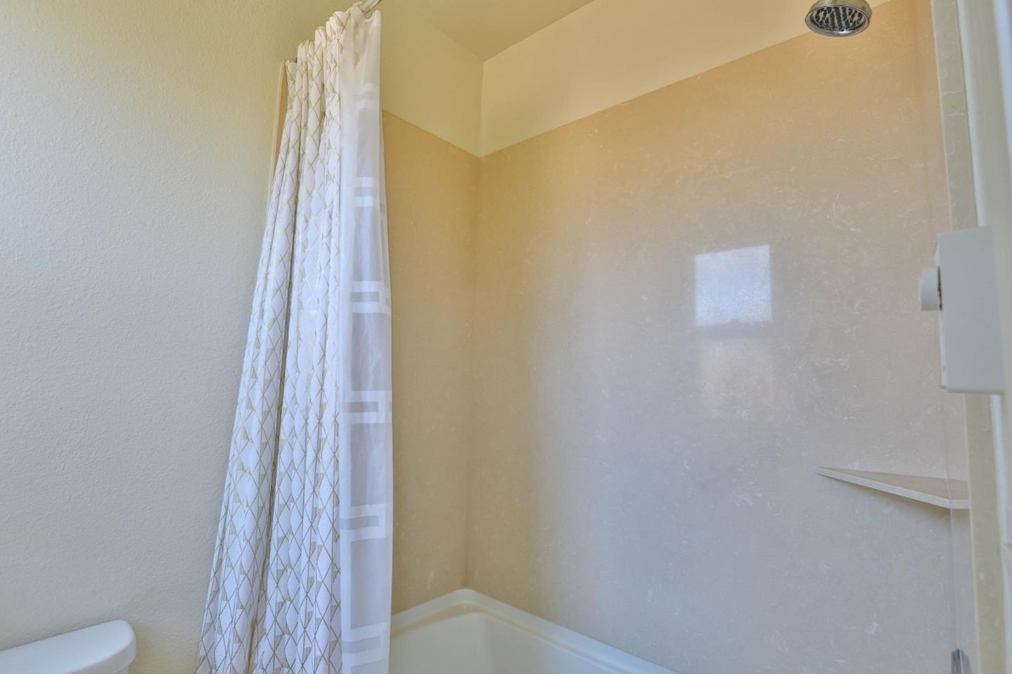 4192 Chiavari Way Manteca, CA 95337 - Photo 51 of 67 a bathroom with a shower curtain and a toilet
