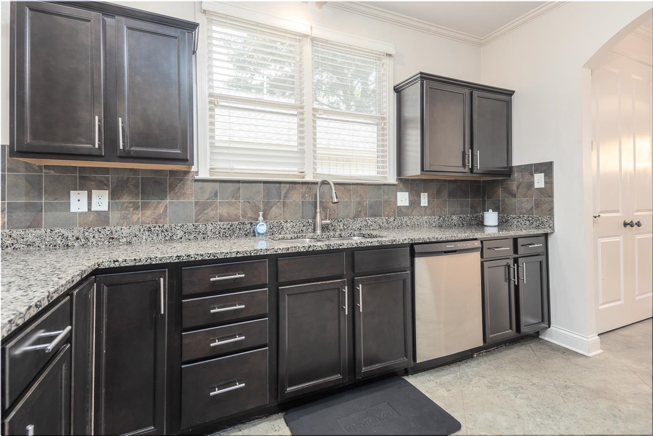 585 Alexander Street Memphis, TN 38111 - Photo 13 of 30 a kitchen with granite countertop cabinets stainless steel appliances a sink and a window