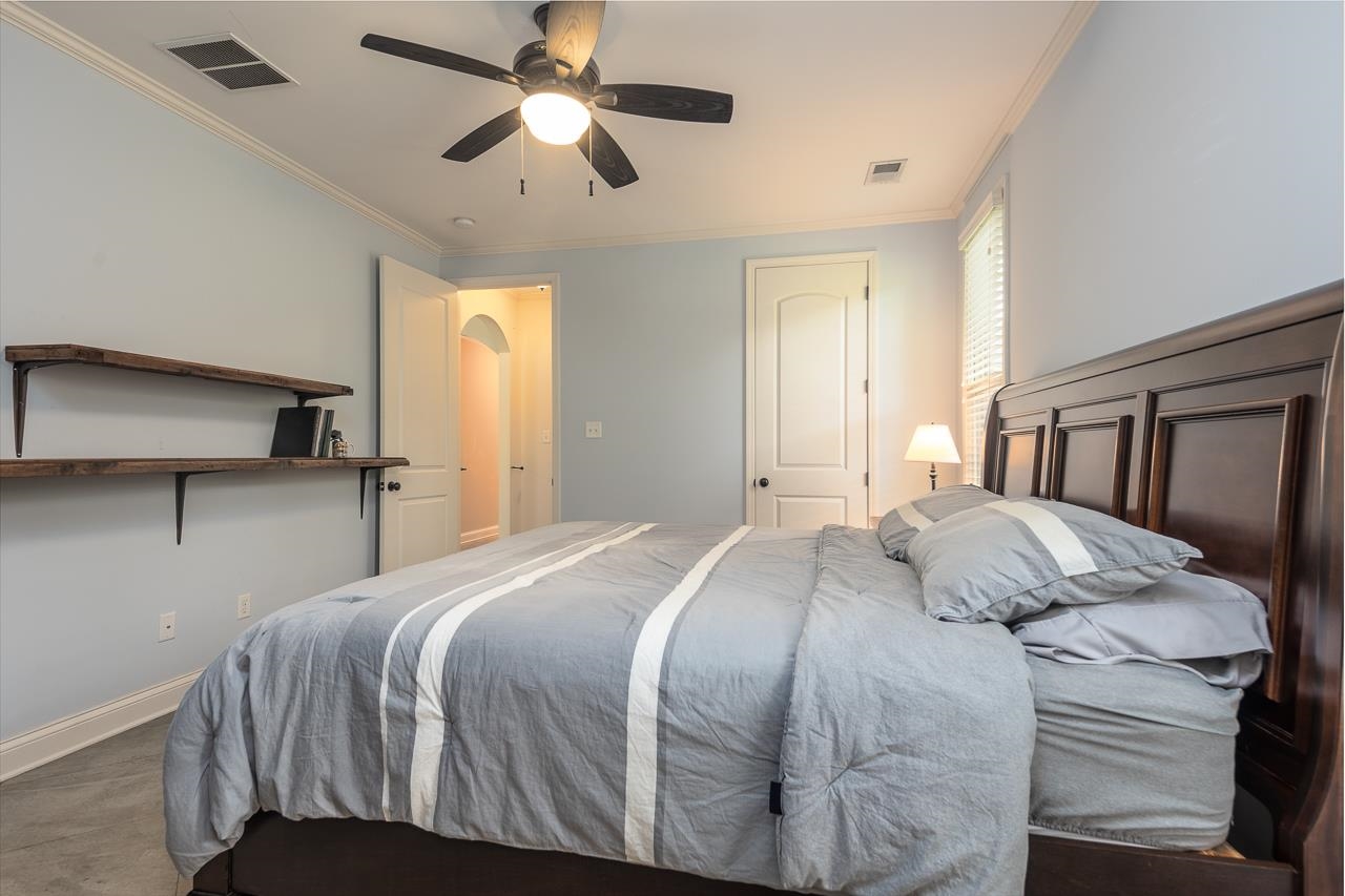 585 Alexander Street Memphis, TN 38111 - Photo 16 of 30 a bedroom with a large bed and a chandelier