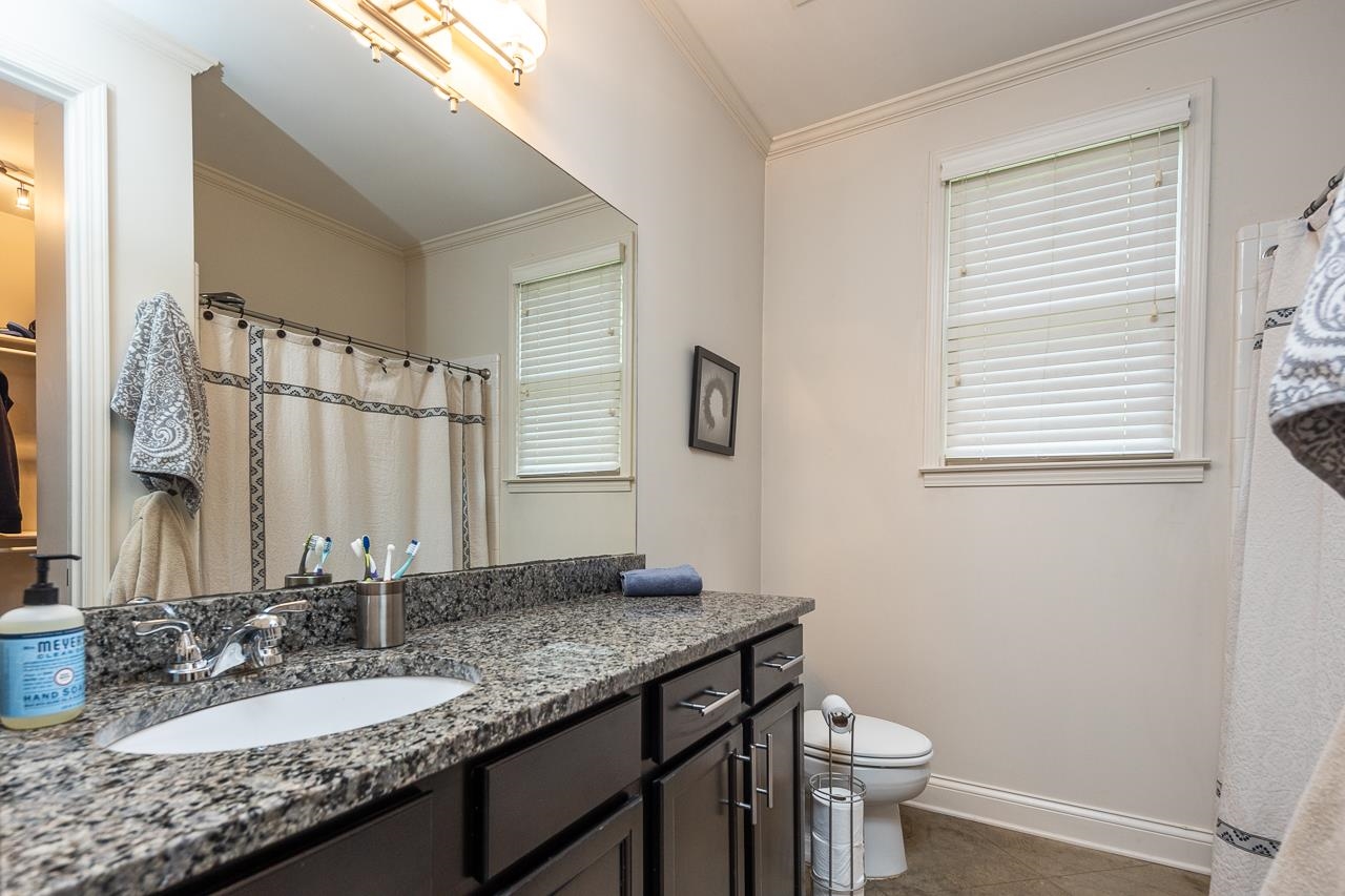 585 Alexander Street Memphis, TN 38111 - Photo 17 of 30 a bathroom with a granite countertop sink toilet and mirror
