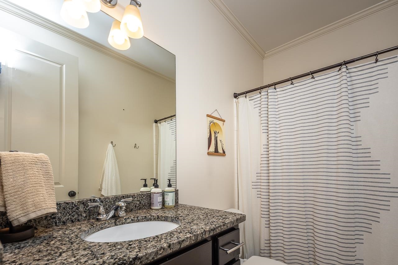 585 Alexander Street Memphis, TN 38111 - Photo 20 of 30 a bathroom with a granite countertop sink and a mirror