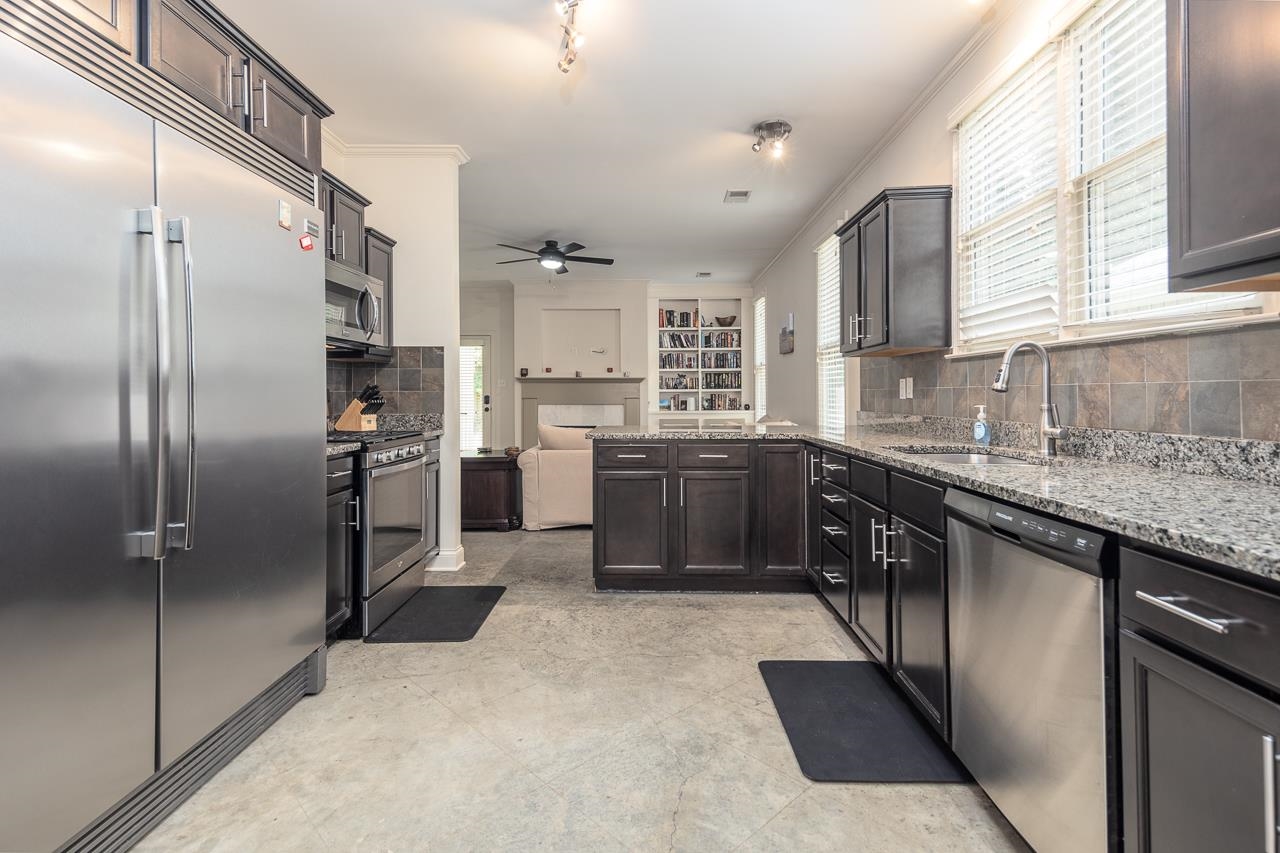 585 Alexander Street Memphis, TN 38111 - Photo 10 of 30 a kitchen with stainless steel appliances granite countertop a refrigerator a sink a stove and a refrigerator