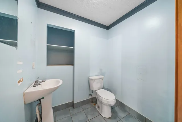 a view of a livingroom with an empty space and a window