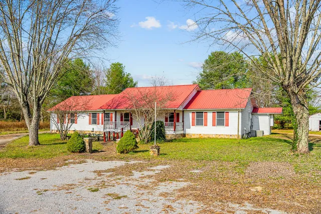 a backyard of a house with yard and outdoor seating