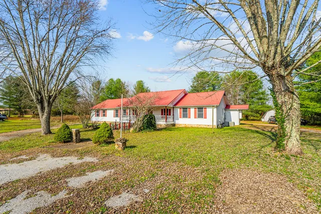 a view of a balcony with chairs and wooden floor