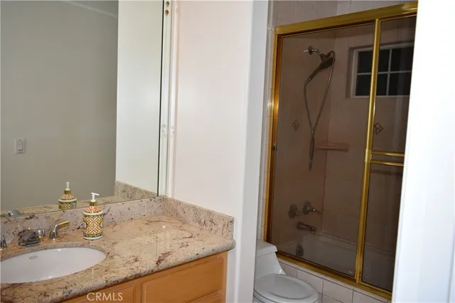 a kitchen with granite countertop sink and cabinets