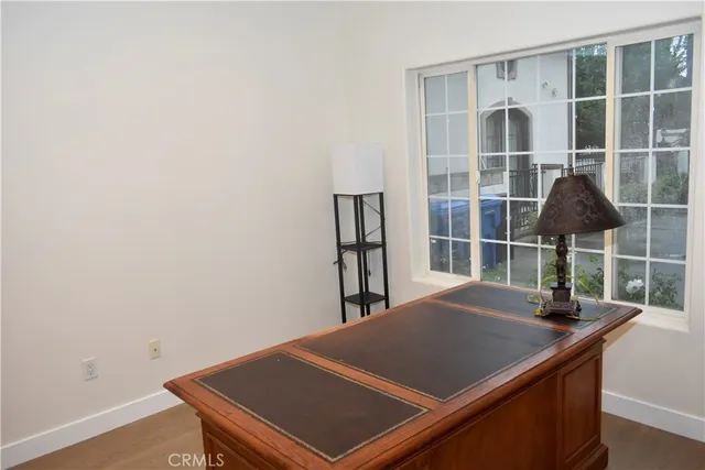 a view of an empty room with a window and a flat screen tv