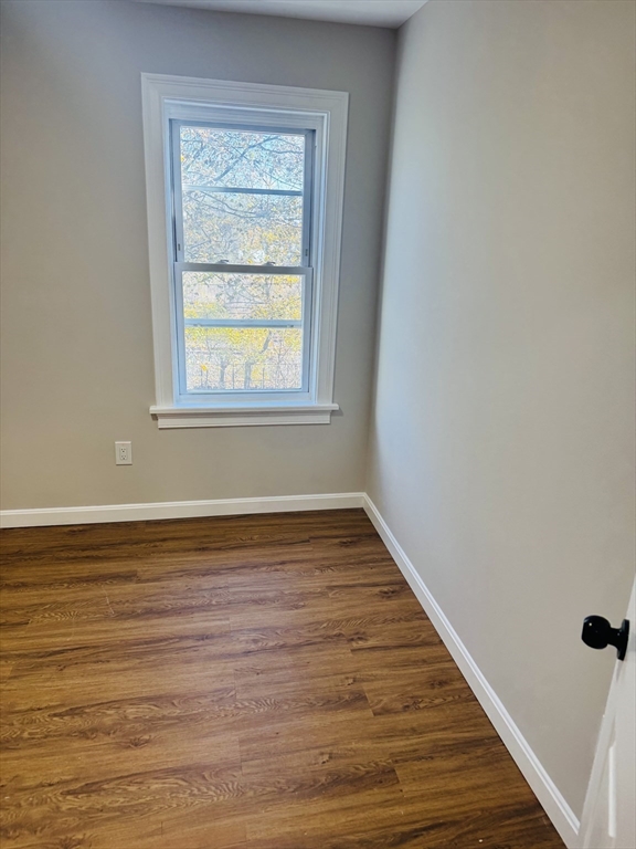 49 Lawrence Street, Unit 2 Salem, MA 01970 - Photo 6 of 13 a view of an empty room with wooden floor and a window