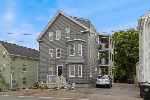 a view of a house with potted plants