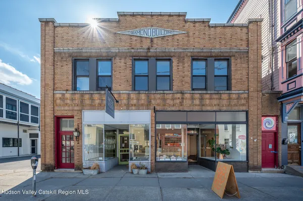 a front view of a brick building with many windows