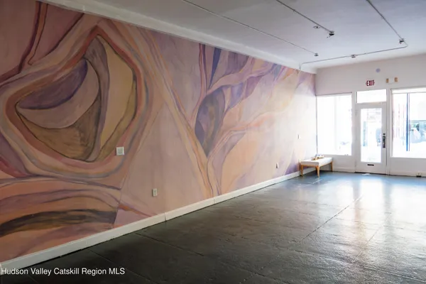 a view of a room with wooden floor and stairs
