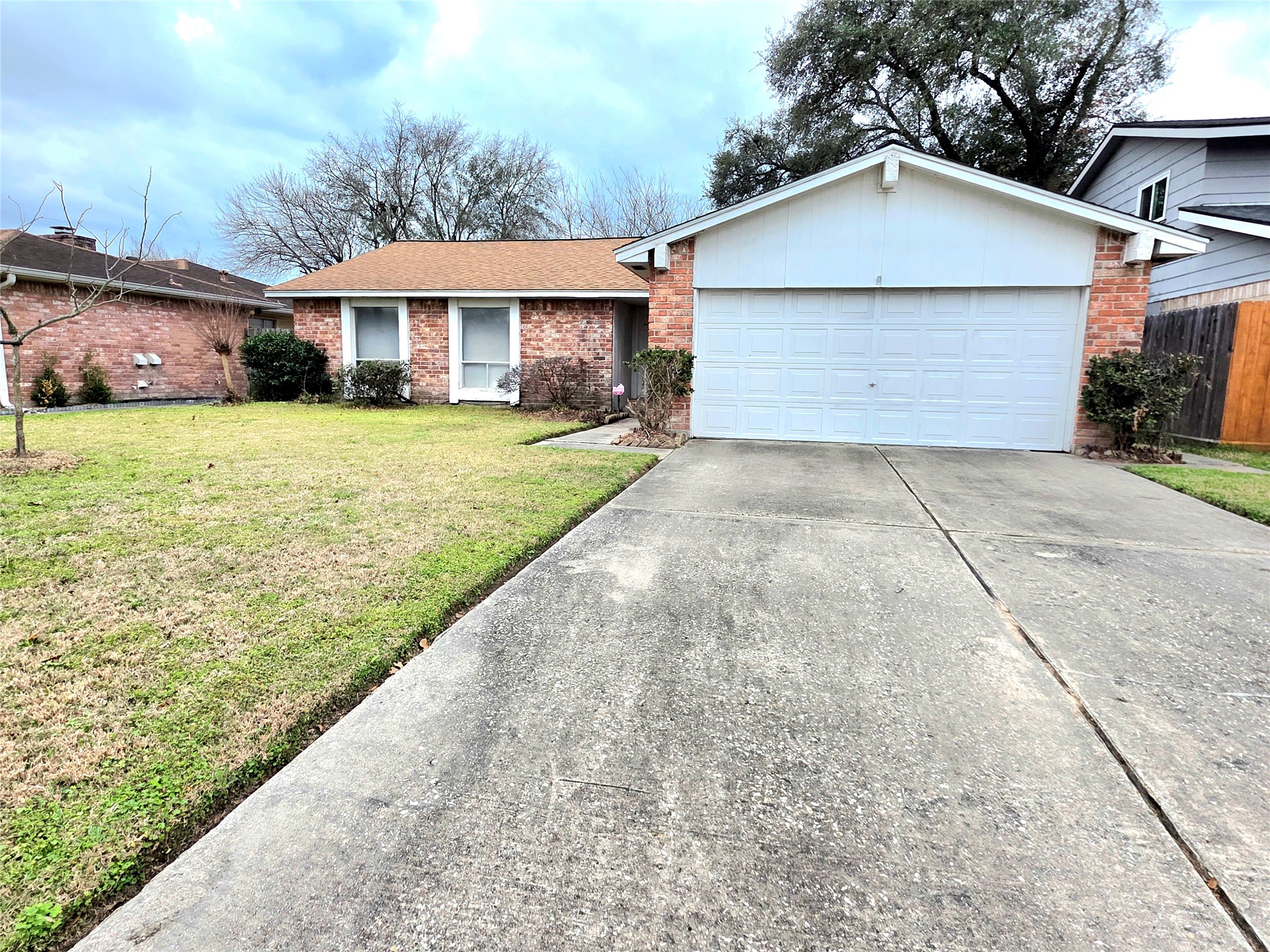 8519 Riverside Walk Lane Houston, TX 77064 - Photo 2 of 10 a front view of a house with a yard and garage
