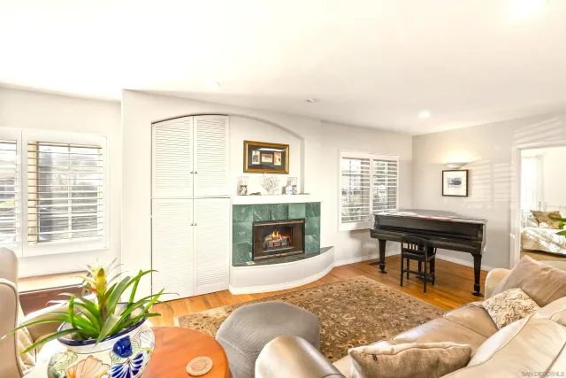 a living room with furniture fireplace and dining table