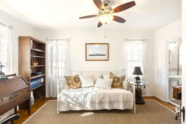 a spacious bedroom with a bed and a chandelier
