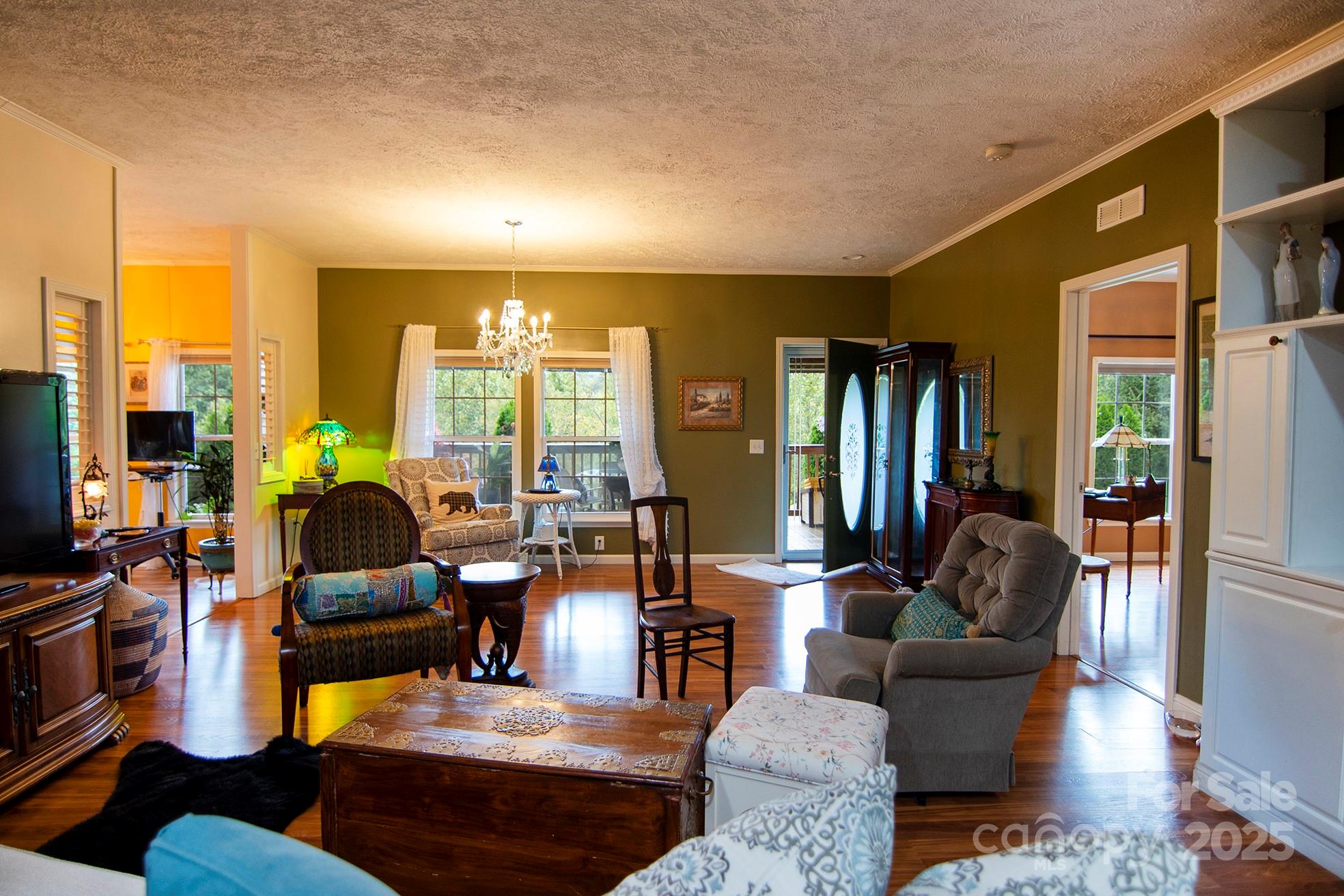 304 Golden Aster Road Swannanoa, NC 28778 - Photo 8 of 27 a living room with furniture and a chandelier