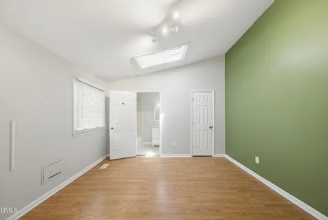 a view of a big room with wooden floor and windows in a room