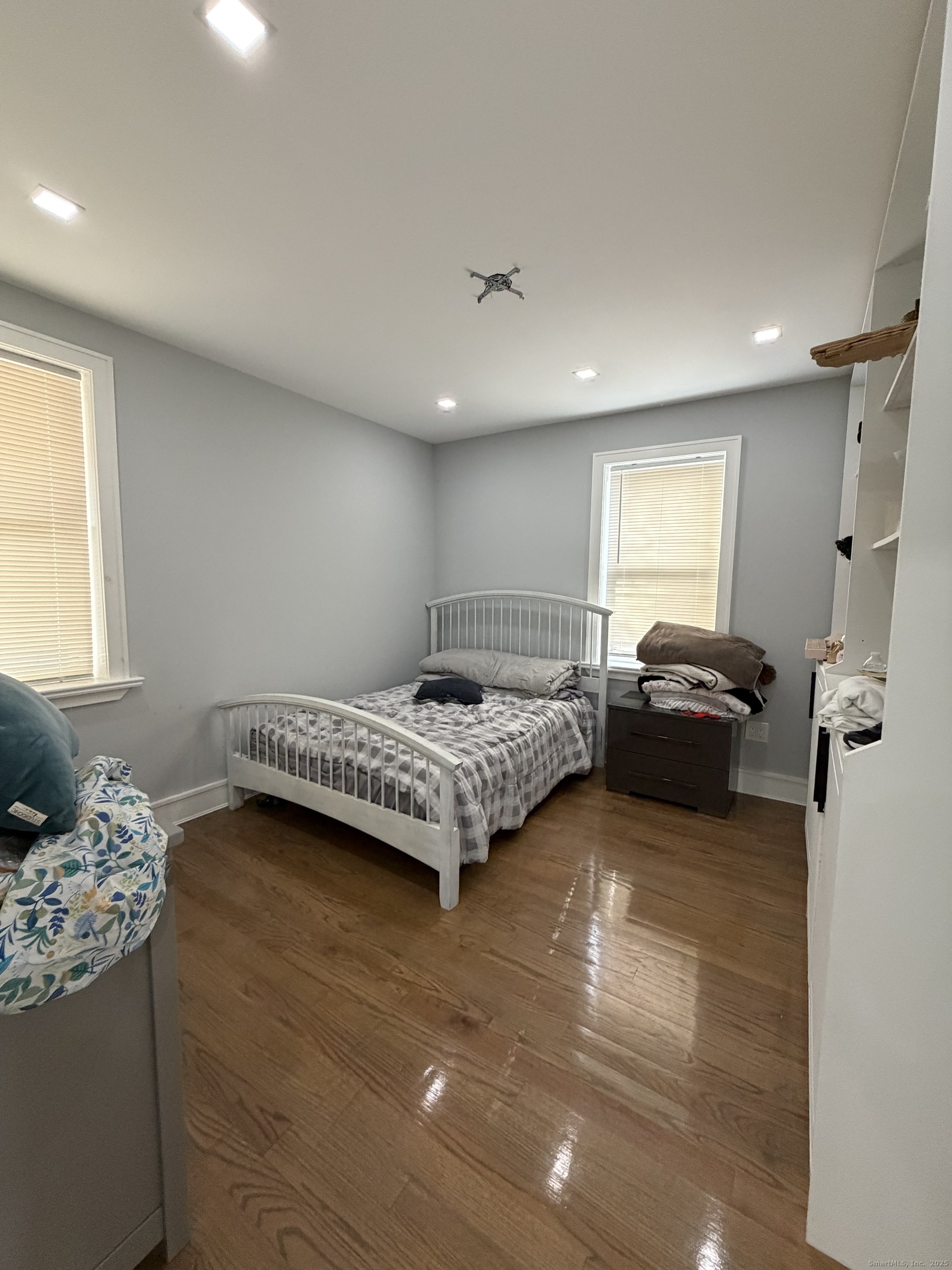 2964 State Street, Unit 1 Hamden, CT 06517 - Photo 11 of 18 a bedroom with a bed and a chair