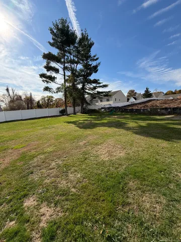 a view of a big yard with an outdoor seating