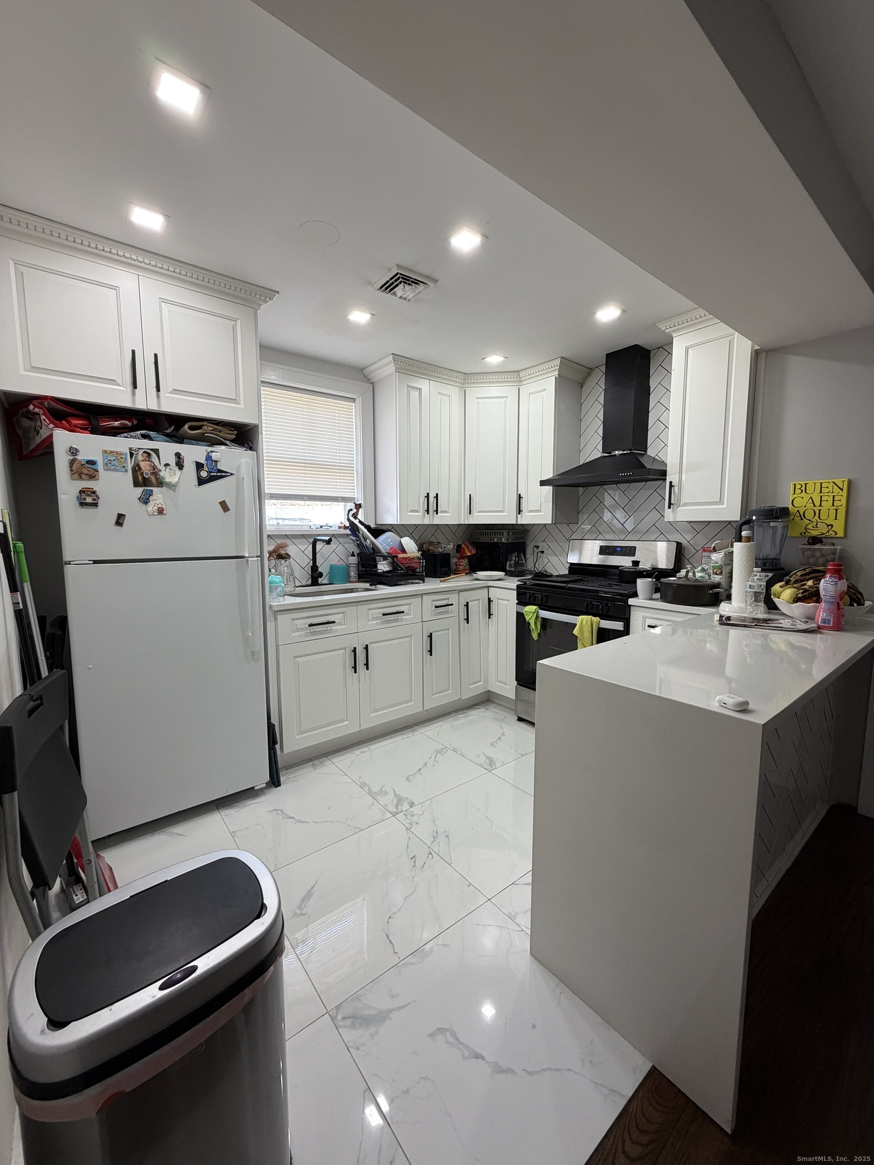2964 State Street, Unit 1 Hamden, CT 06517 - Photo 2 of 18 a kitchen with a sink a stove a refrigerator cabinets and a counter top space
