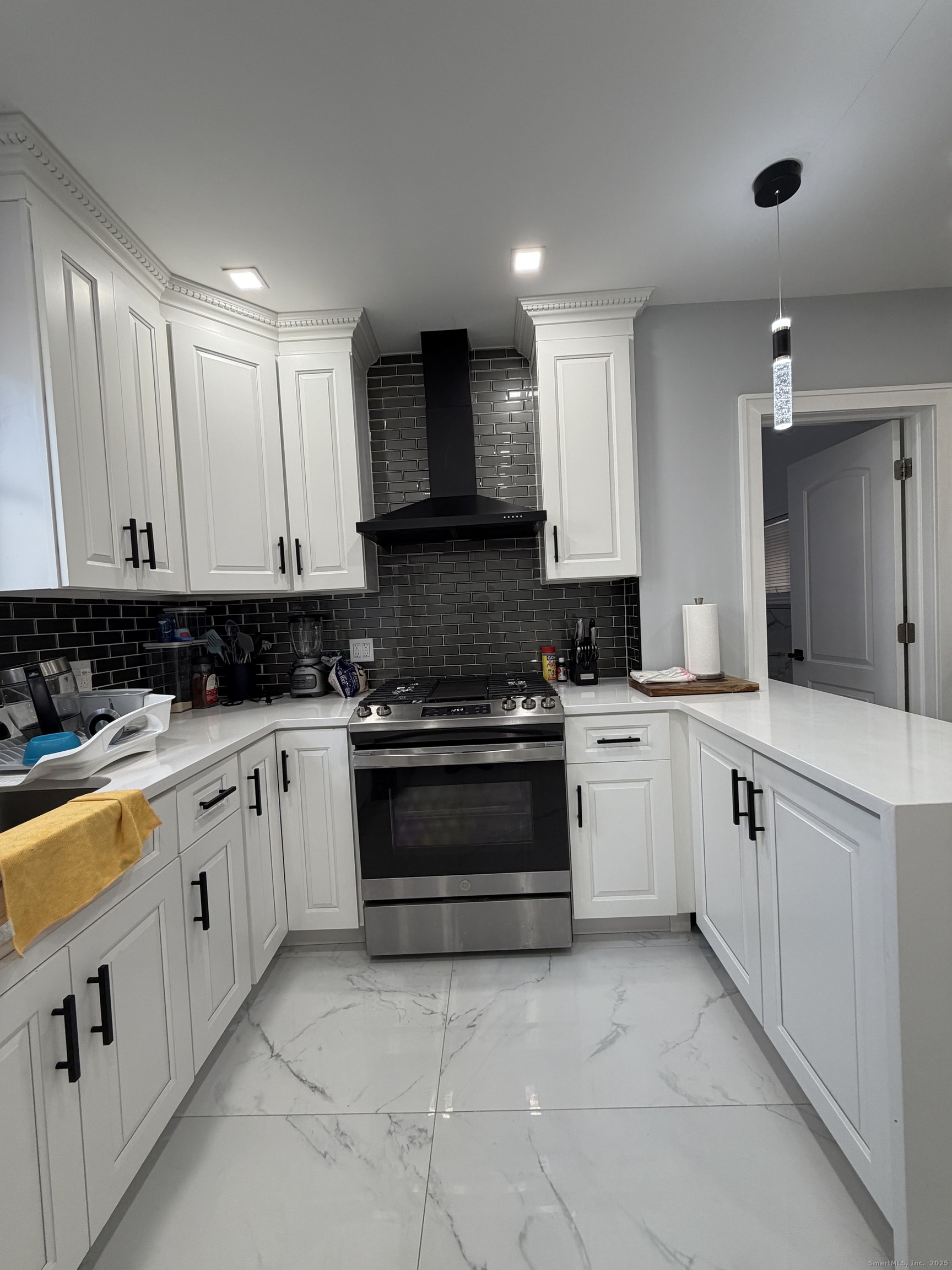 2964 State Street, Unit 1 Hamden, CT 06517 - Photo 3 of 18 a kitchen with stainless steel appliances granite countertop white cabinets granite counter tops and a stove