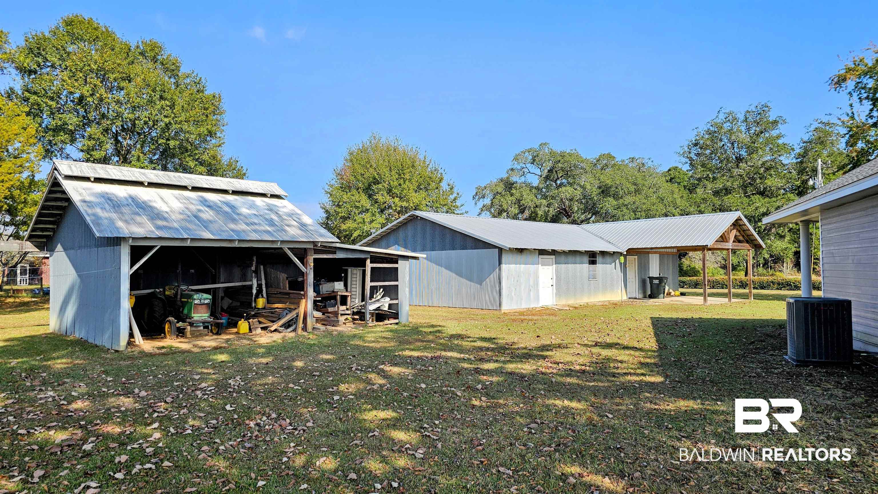 9275 Crawford Road Elberta, AL 36530 - Photo 7 of 28 Back of house with an outbuilding, a pole building, and a metal roof