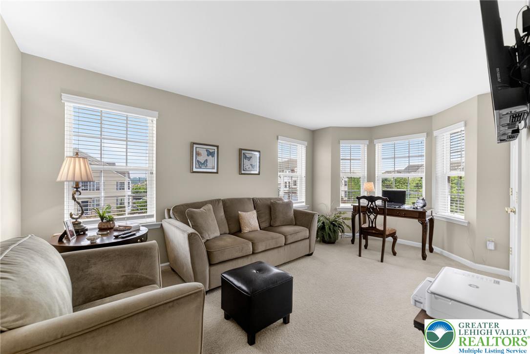 5440 Spring Ridge Drive West Macungie, PA 18062 - Photo 22 of 40 A versatile living space with plentiful windows, ideal for relaxation or a home office setup.