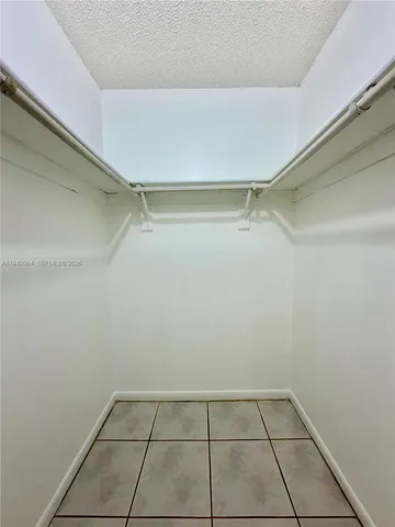 a bathroom with a granite countertop sink mirror vanity and toilet