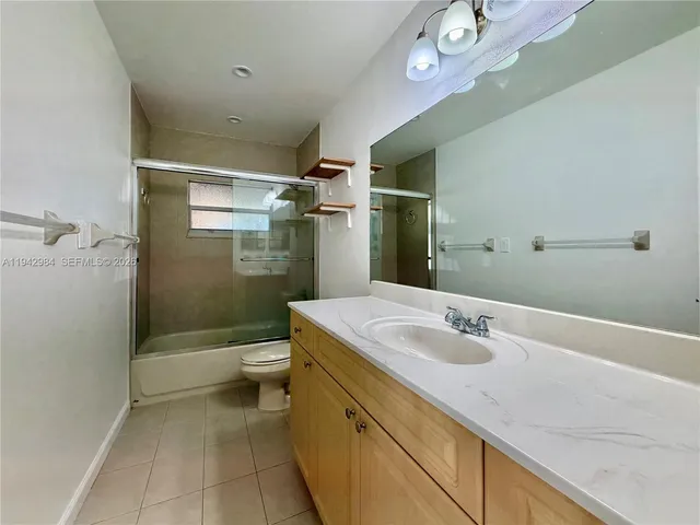 an empty room with closet and a chandelier fan