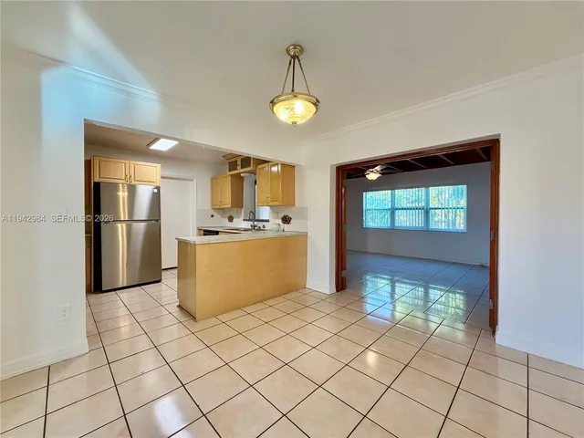 a view of kitchen with furniture and refrigerator
