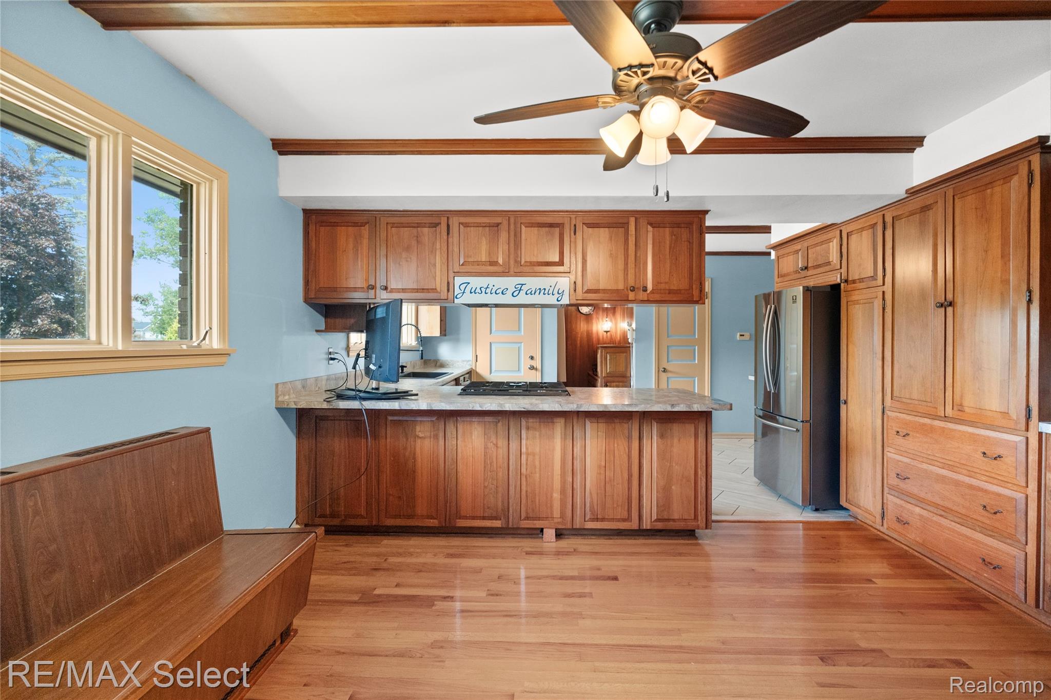 11080 Lapeer Road Davison, MI 48423 - Photo 32 of 64 Hardwood flooring, wood-finish cabinetry, exposed wood beams, stainless steel refrigerator, and a ceiling fan