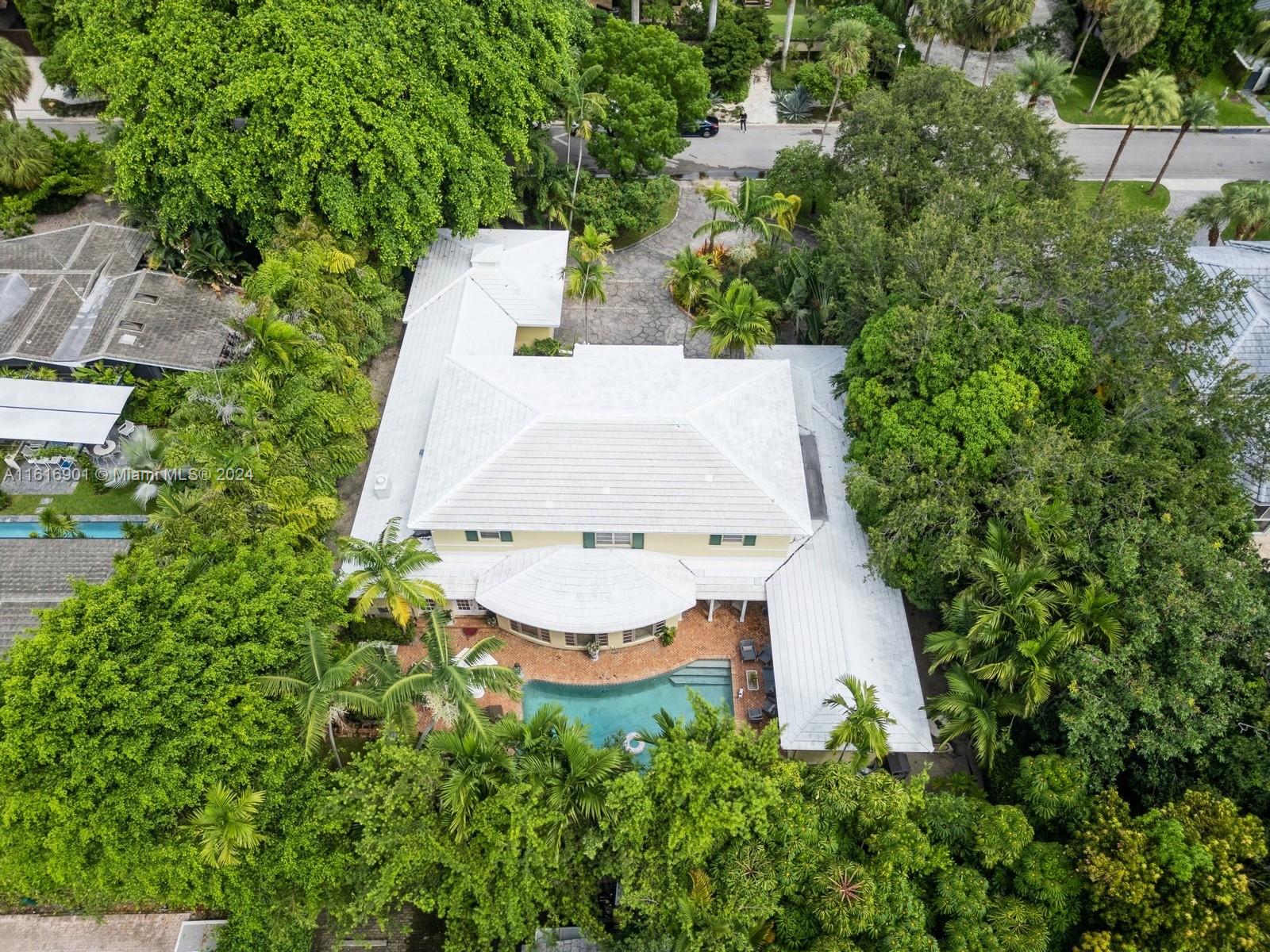4430 Sabal Palm Road Miami, FL 33137 - Photo 29 of 38 an aerial view of a house with yard and trees in the background