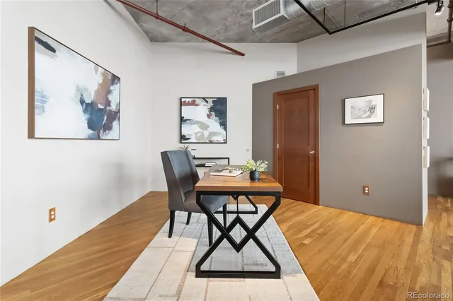 a workspace room with furniture and wooden floor