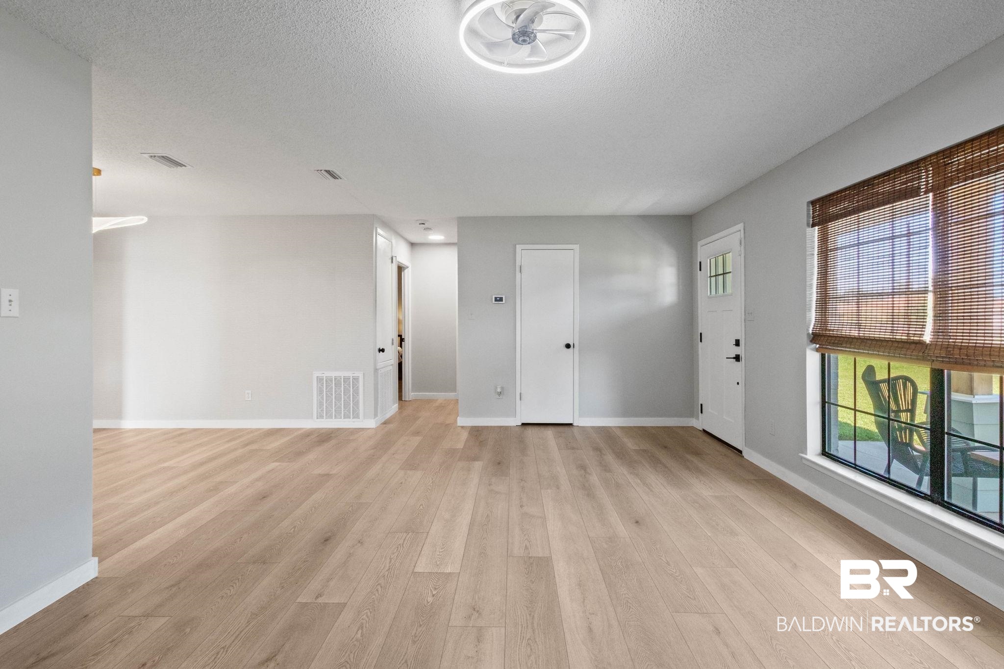 524 Ariel Avenue Foley, AL 36535 - Photo 7 of 37 Open-concept interior featuring light wood-finish flooring, a contemporary ceiling fan, and light gray wall paint