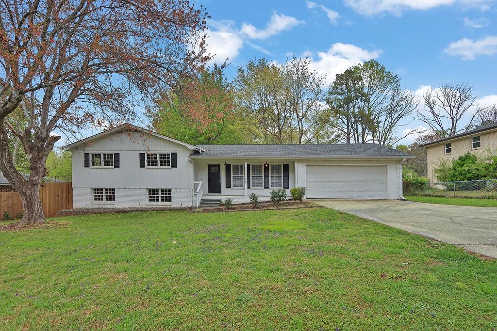 1531 Piedmont Road Marietta, GA 30066 - Photo 1 of 1 a front view of a house with a garden and trees