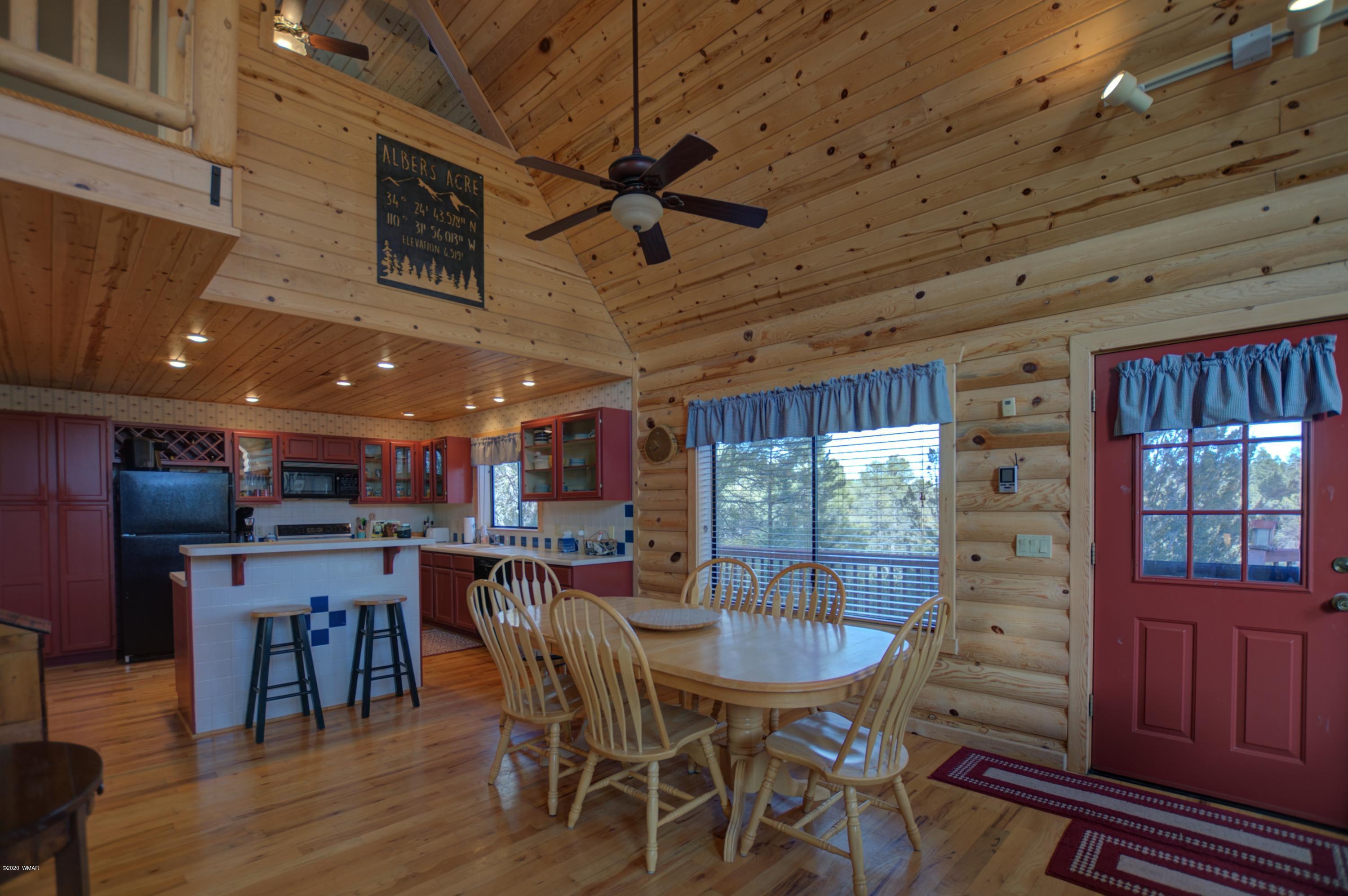 2957 Ranch House Road Overgaard, AZ 85933 - Photo 6 of 24 a view of a dining room with furniture window and wooden floor