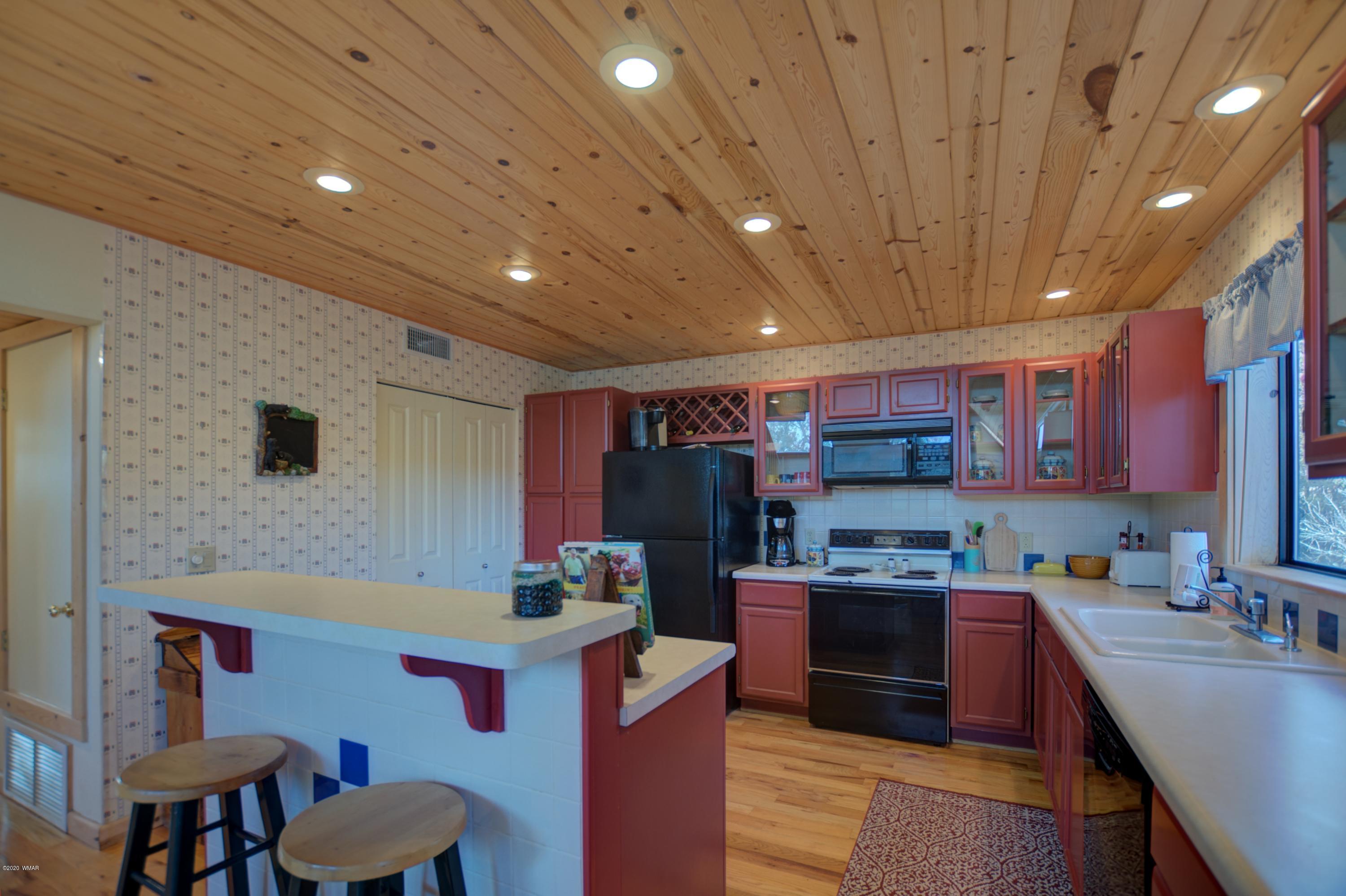 2957 Ranch House Road Overgaard, AZ 85933 - Photo 8 of 24 a kitchen that has a lot of cabinets in it and stainless steel appliances