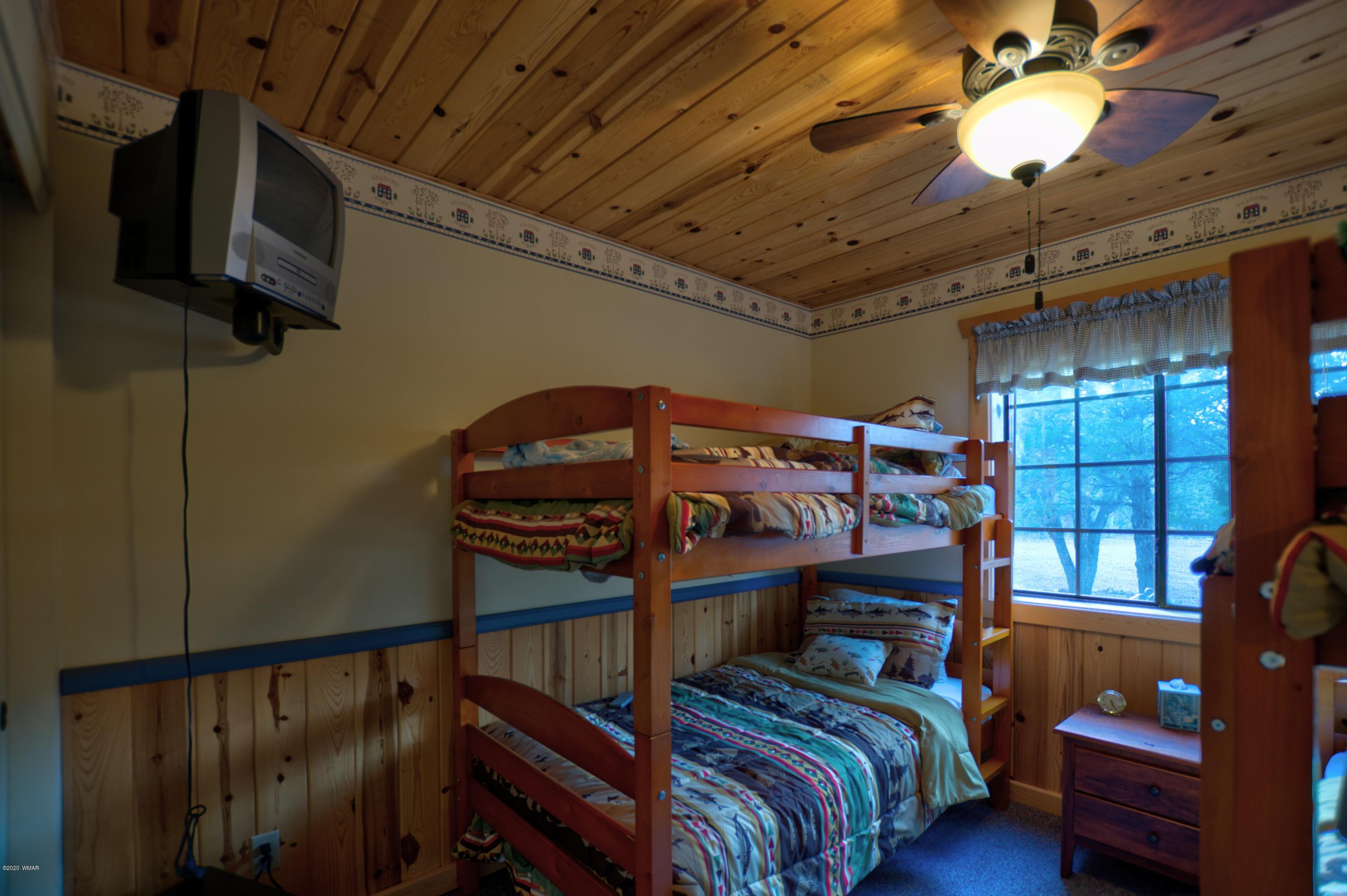 2957 Ranch House Road Overgaard, AZ 85933 - Photo 9 of 24 a bedroom with furniture and a window