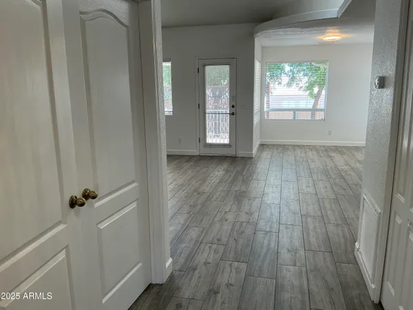 a view of wooden floor and windows in a room
