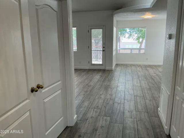 a view of wooden floor and windows in a room