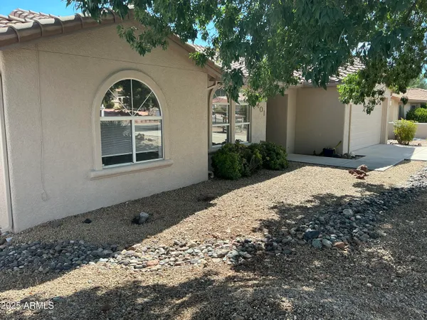a front view of a house with a tree
